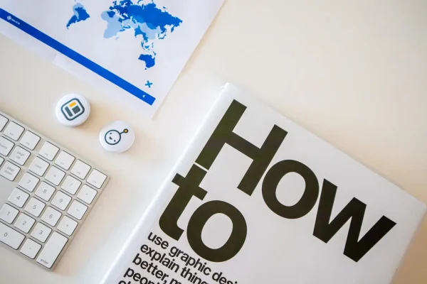 Graphic design book and workspace setup illustrating the planning phase of building a website for Durham Region